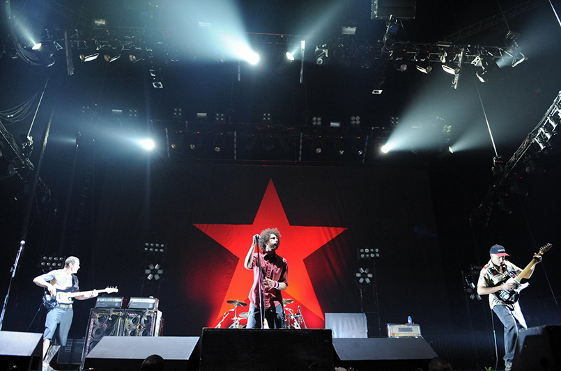 US band Rage Against the Machine band performs on stage on June 4, 2008 at the Bercy Palais Omnisport in Paris as part of the band's European tour. Founded by guitarist Tom Morello, Rage Against the Machine broke up once prior to reunited in 2007. At center stands singer Frontman Zach de la Rocha next to guitarist Tom Morello (R) and bass guitarist Tim Commerford. AFP PHOTO BERTRAND LANGLOIS (Photo credit should read BERTRAND LANGLOIS/AFP/Getty Images)